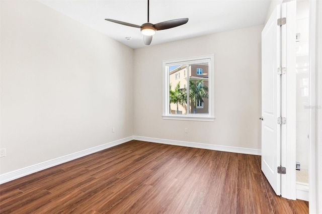 unfurnished room with dark hardwood / wood-style flooring and ceiling fan