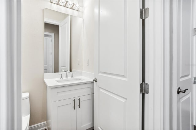 bathroom with toilet and oversized vanity