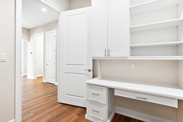 unfurnished office featuring hardwood / wood-style floors