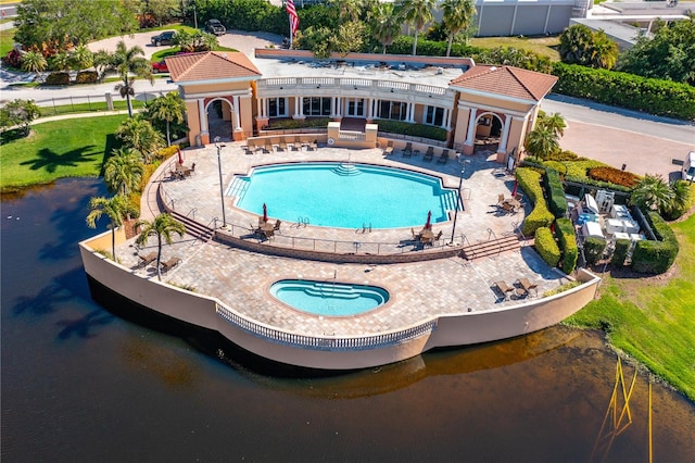 view of pool featuring a yard, a hot tub, and a patio