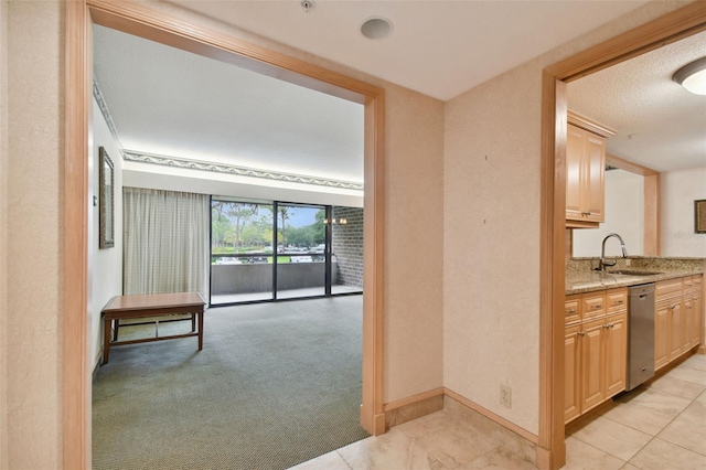 hallway with sink and light tile flooring