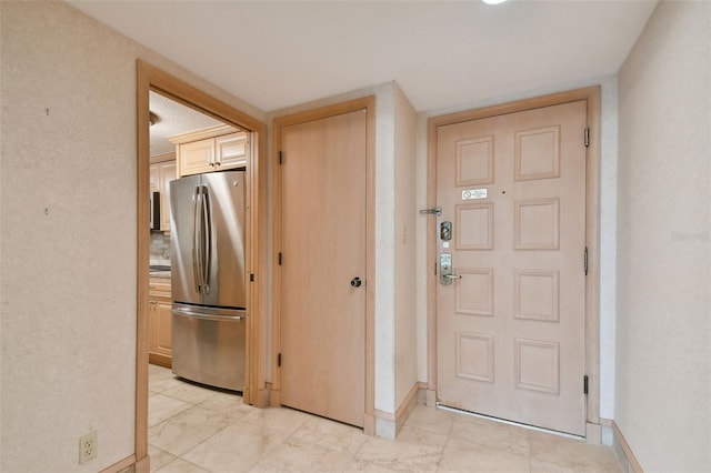 foyer entrance with light tile floors