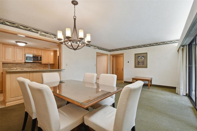 carpeted dining area with a textured ceiling and a chandelier