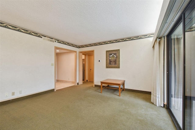 unfurnished room with dark carpet and a textured ceiling