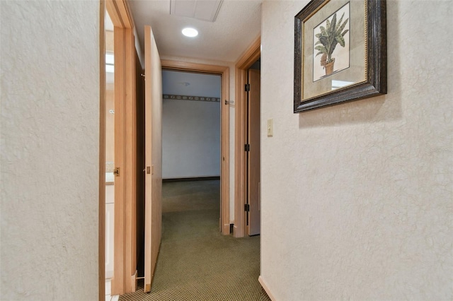 hallway featuring dark colored carpet