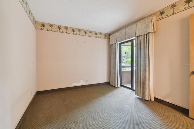 carpeted empty room with a textured ceiling