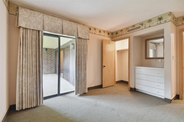 unfurnished bedroom featuring multiple windows, access to exterior, and light colored carpet