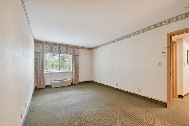 carpeted empty room featuring a wall unit AC