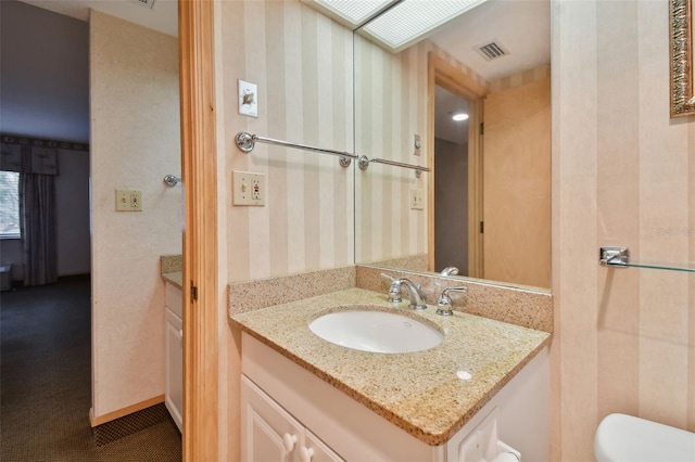 bathroom with toilet and vanity