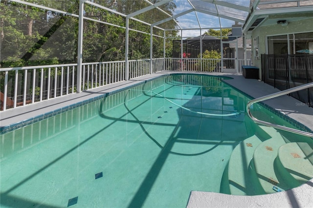 view of swimming pool with a lanai