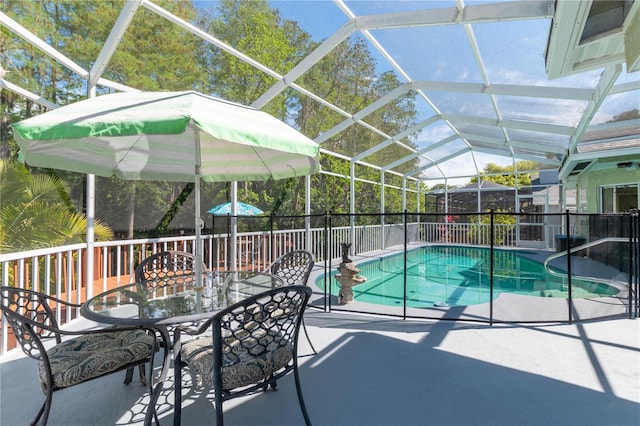 view of pool featuring a patio and glass enclosure