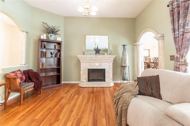 living room featuring a chandelier and light hardwood / wood-style floors