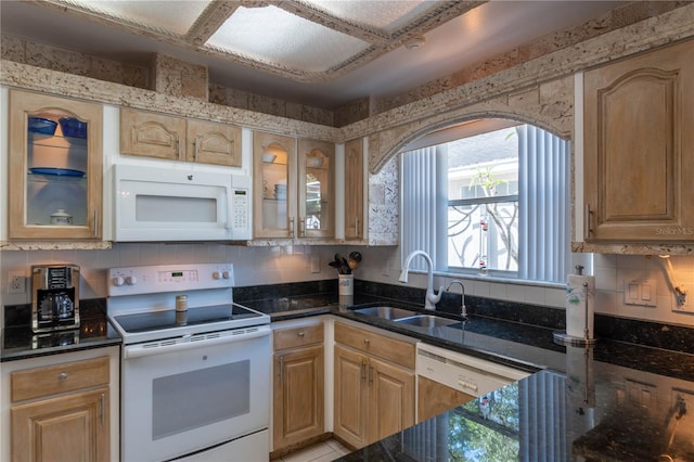 kitchen featuring sink, light brown cabinets, and white appliances