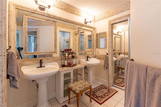 bathroom with tile patterned floors and a textured ceiling