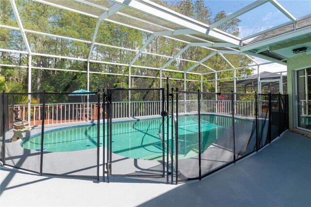 view of pool with a patio and a lanai