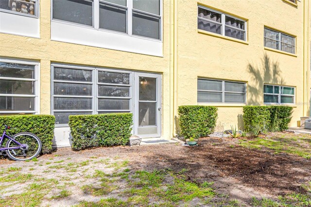 property entrance featuring central AC unit