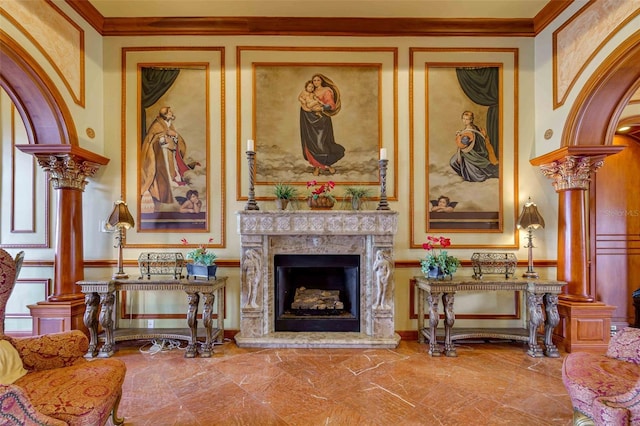 sitting room with a fireplace, ornamental molding, and decorative columns