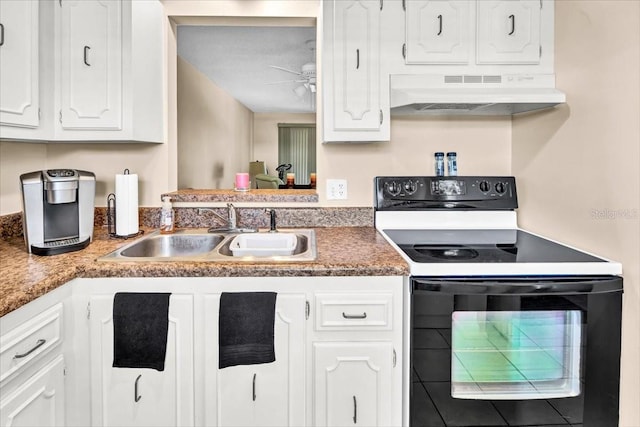 kitchen featuring sink, wall chimney exhaust hood, electric range, and white cabinetry