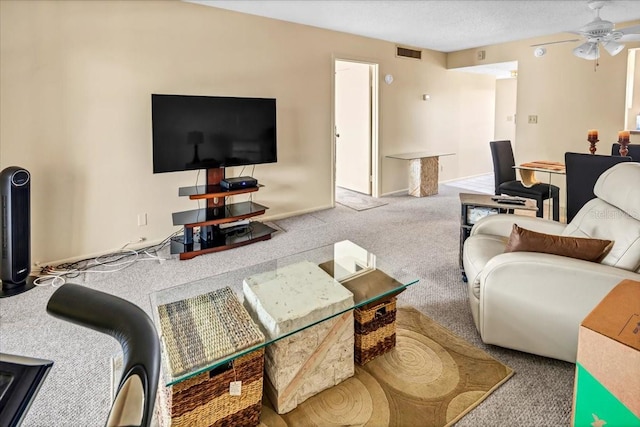 carpeted living room with a textured ceiling and ceiling fan