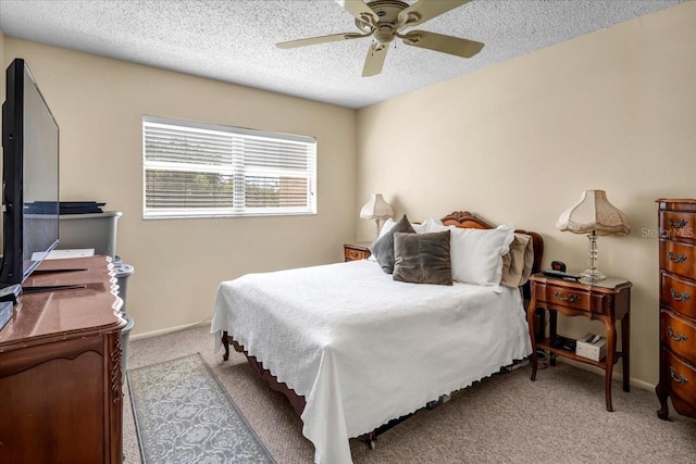 carpeted bedroom with ceiling fan and a textured ceiling