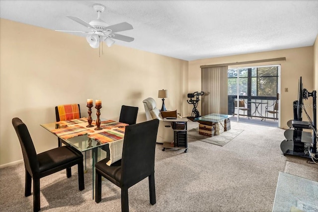 carpeted dining room with ceiling fan and a textured ceiling