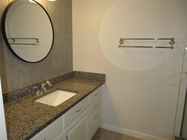 bathroom with vanity and baseboards