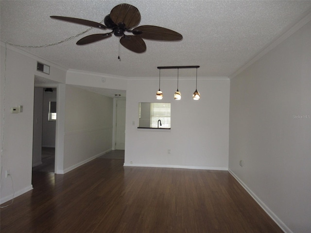 unfurnished room featuring crown molding, visible vents, a textured ceiling, wood finished floors, and baseboards