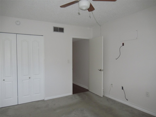 unfurnished bedroom with a textured ceiling, a closet, visible vents, and baseboards