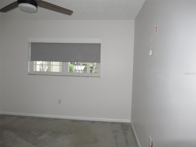 empty room with carpet, ceiling fan, a textured ceiling, and baseboards