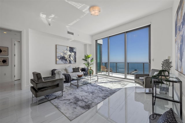 tiled living room with a water view