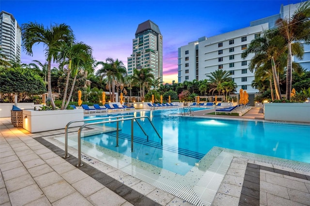 view of pool at dusk