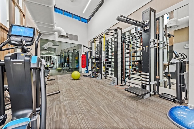 exercise room with light colored carpet