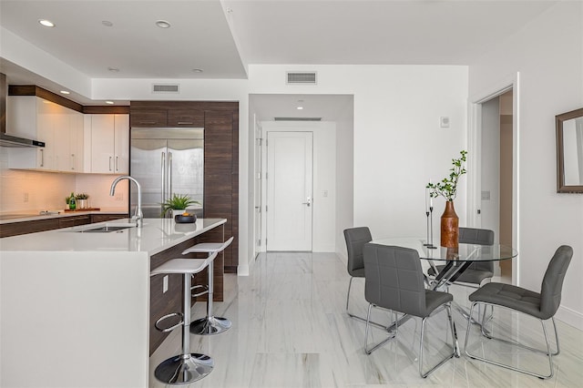 tiled dining space featuring sink