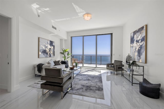 living room with a water view and light tile floors