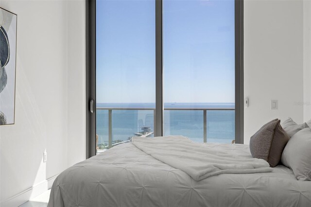 bedroom featuring a water view