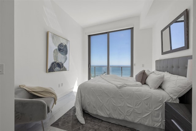 bedroom with tile flooring and a water view