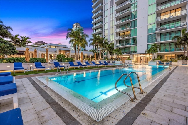 view of pool at dusk