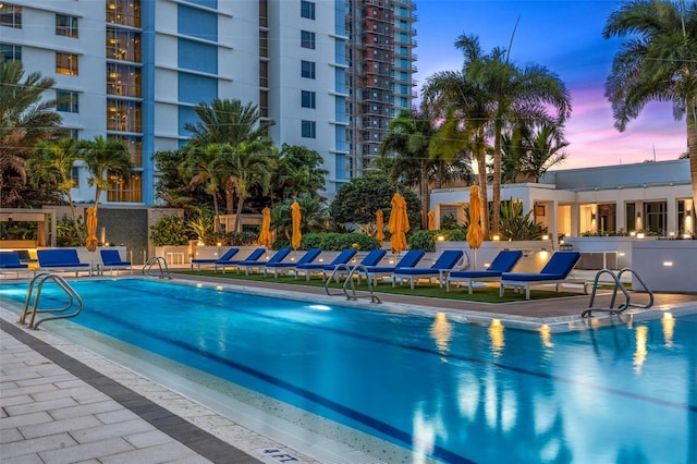 view of pool at dusk