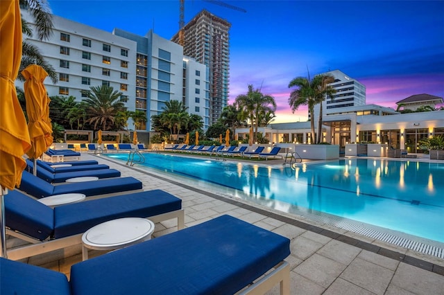 pool at dusk with a patio