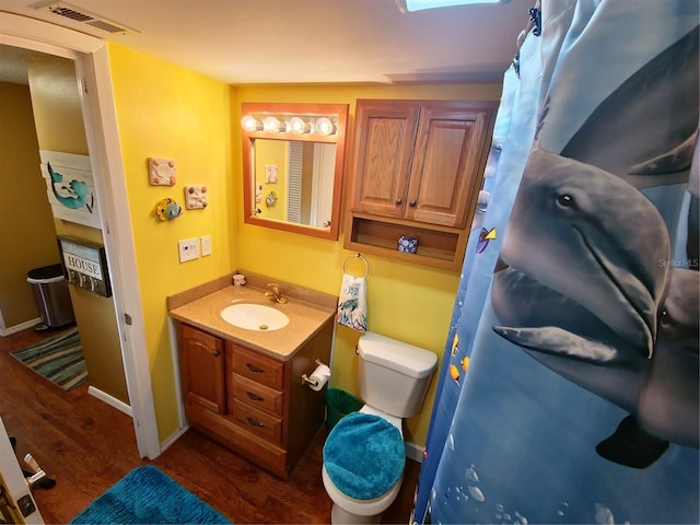 bathroom featuring hardwood / wood-style floors, toilet, and vanity