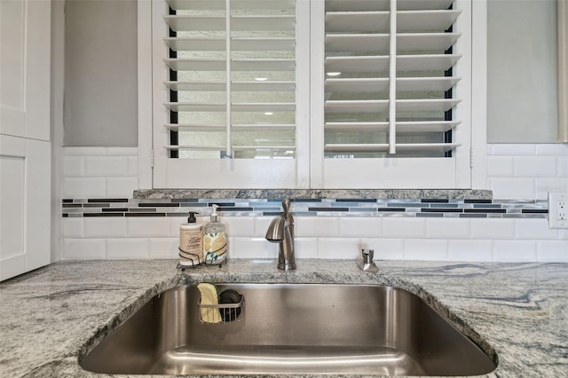 room details featuring sink and tasteful backsplash