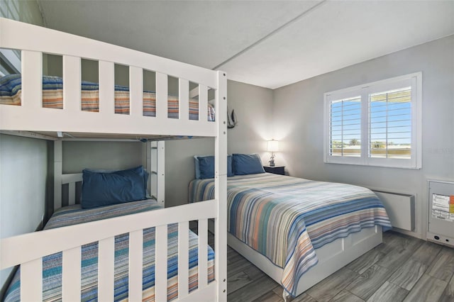 bedroom with dark wood-type flooring