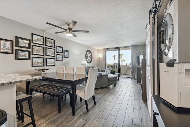 dining room featuring dark hardwood / wood-style floors, a textured ceiling, expansive windows, and ceiling fan