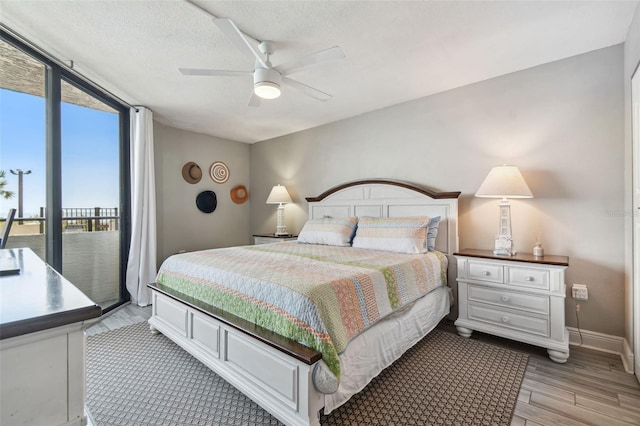 bedroom featuring a textured ceiling, light hardwood / wood-style floors, and ceiling fan