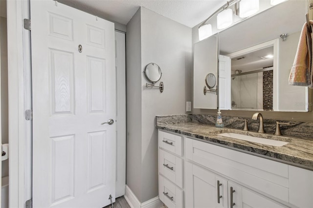 bathroom featuring vanity and a textured ceiling