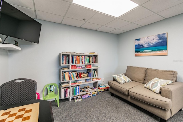 interior space featuring a paneled ceiling and carpet floors