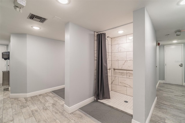 bathroom with curtained shower and hardwood / wood-style floors