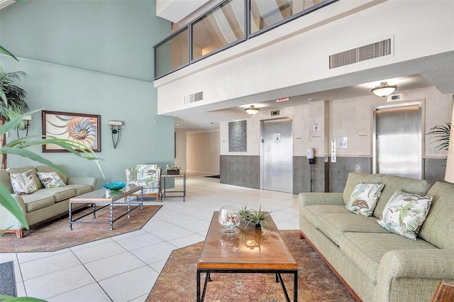 tiled living room with elevator and a towering ceiling