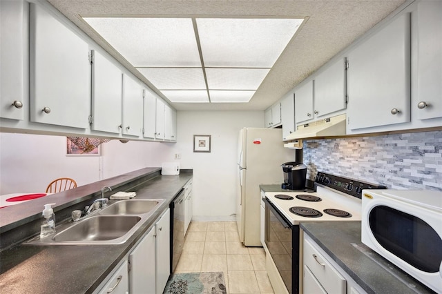 kitchen featuring white cabinets, sink, white appliances, light tile flooring, and tasteful backsplash