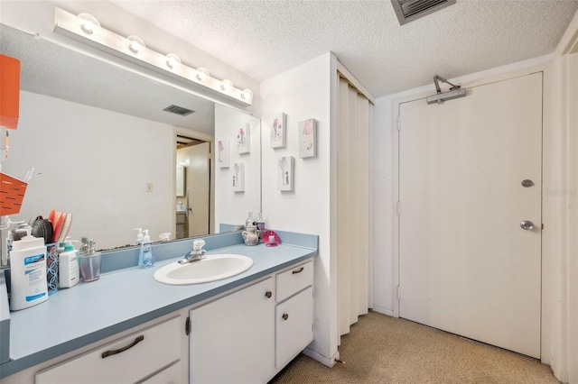 bathroom featuring vanity and a textured ceiling